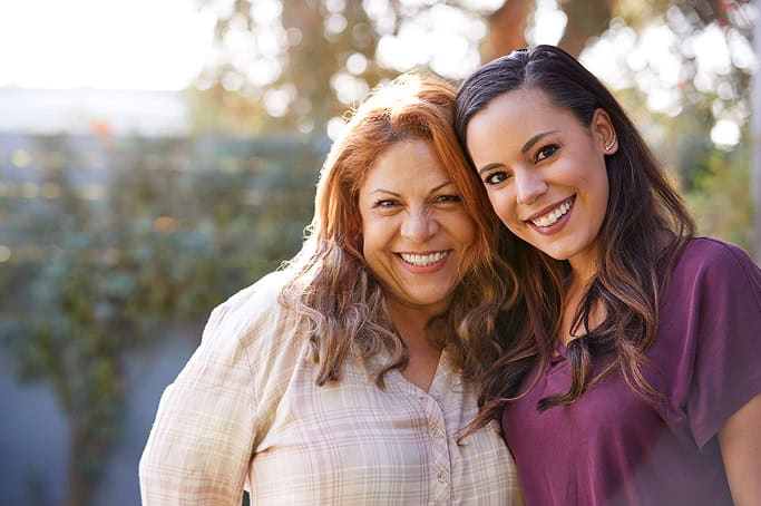 Happy women enjoying nature and friendship in an outdoor setting.