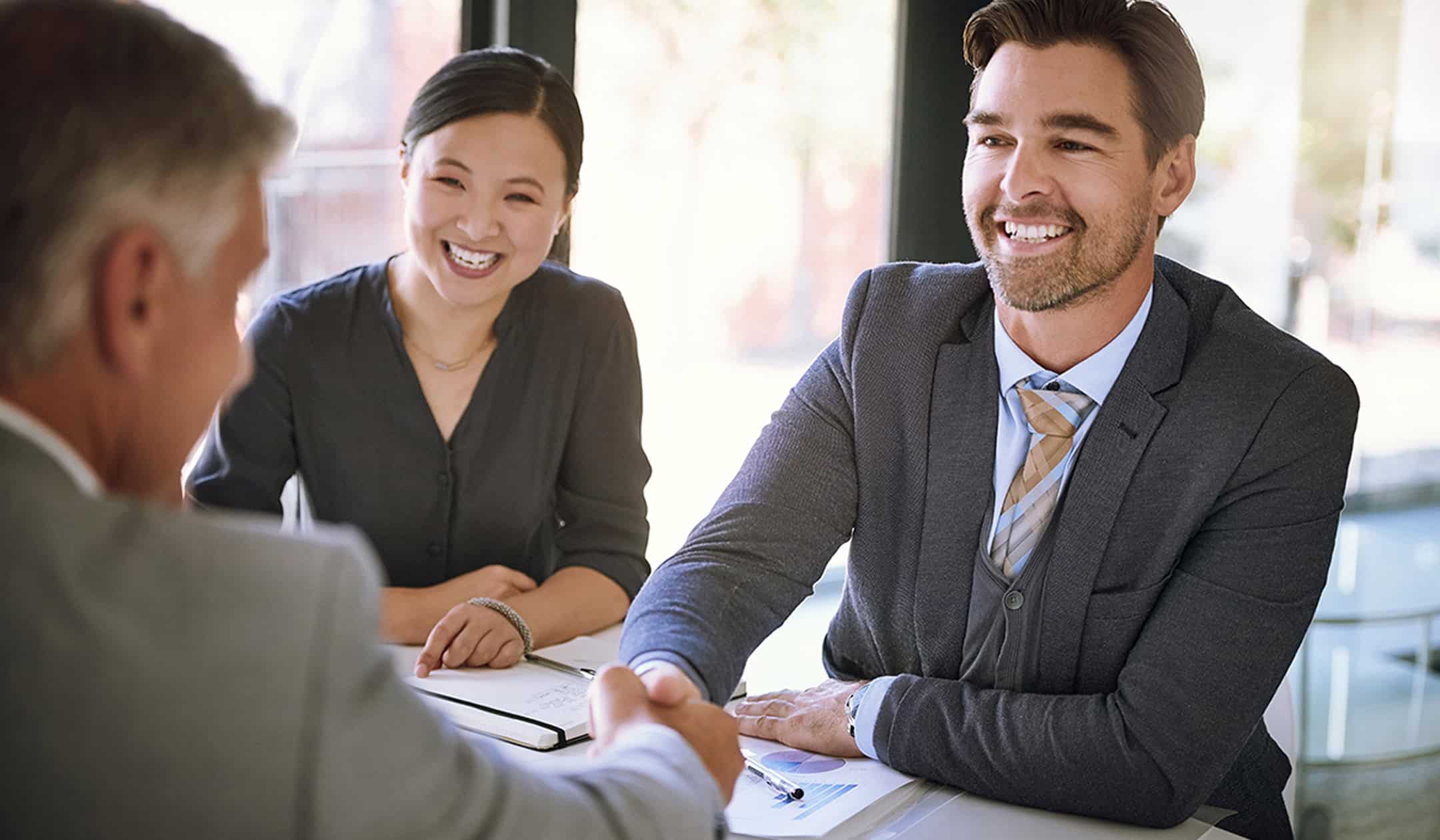 Real estate agents discussing new home options with clients.